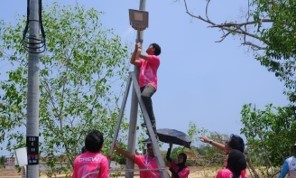 Volunteers installing a solar-powered light