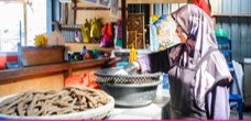 Woman entrepreneur preparing food at her stall