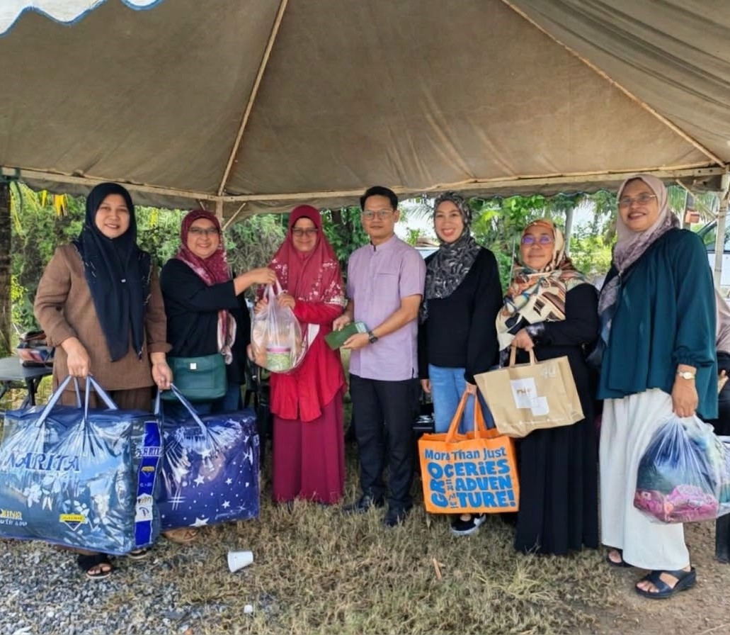 Community members presenting donated supplies at a PKL gathering